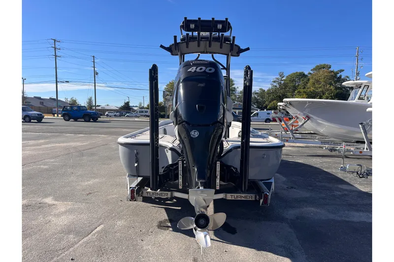 Slide: The Image of 2020 Turner Boatworks 2410 VS with powerful outboard motor in a parking lot. - 4