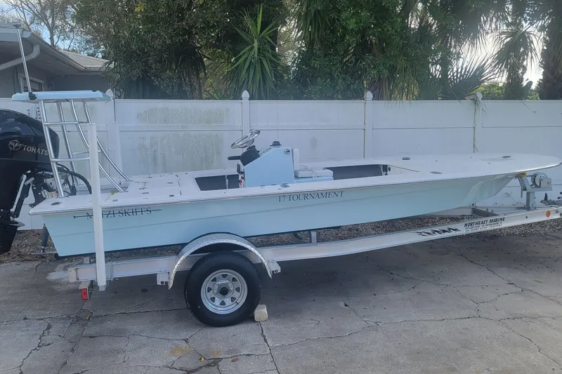 The Image of 2026 Mitzi Skiffs 17 Tournament boat on trailer, parked outdoors. - 0