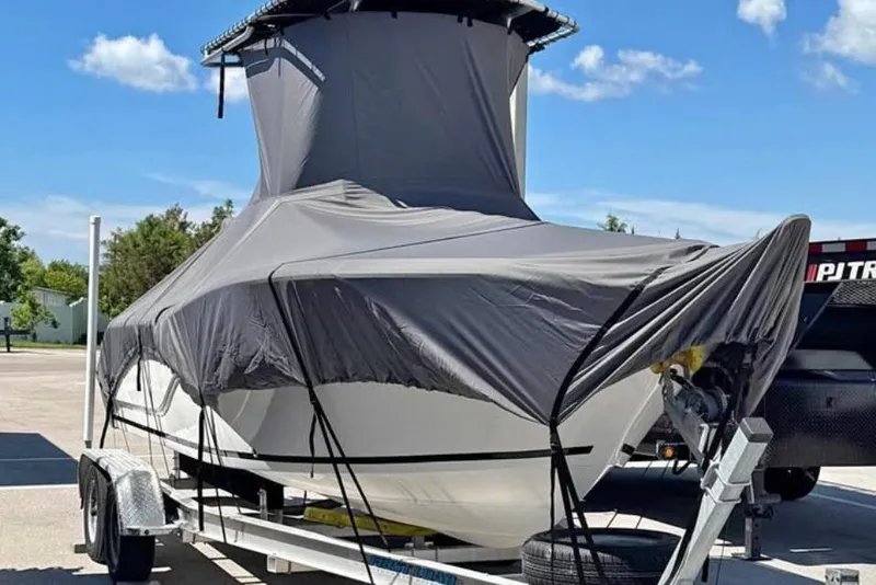 The Image of 2018 Sea Fox 206 Commander boat covered on trailer under clear blue sky. - 0