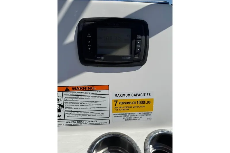 Slide: The Image of 2018 Sea Fox 206 Commander dashboard with warning labels and capacity information. - 13
