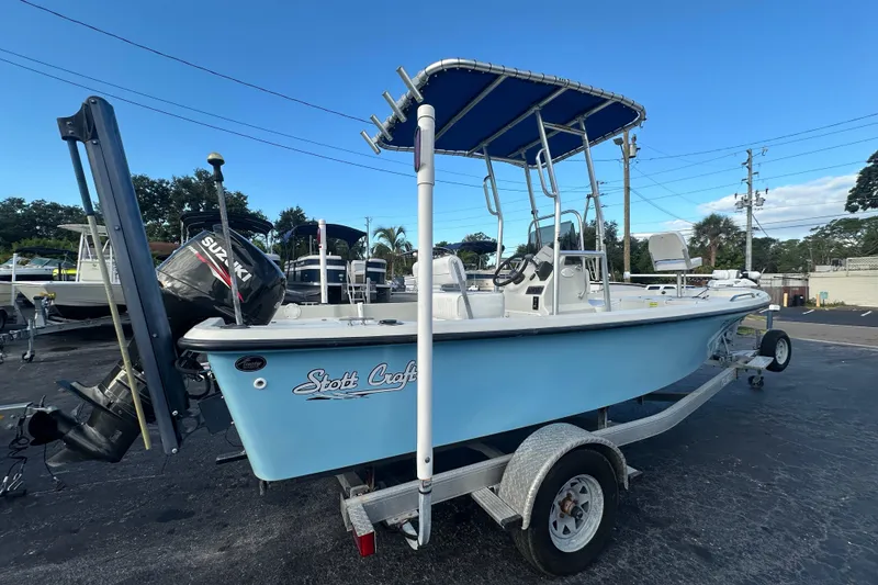 Slide: The Image of 2016 Stott Craft SCV202 boat with Suzuki outboard motor on trailer, blue hull, and T-top canopy. - 5