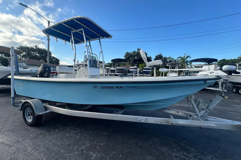 Slide: The Image of 2016 Stott Craft SCV202 boat on trailer with blue canopy, parked outdoors. - 7
