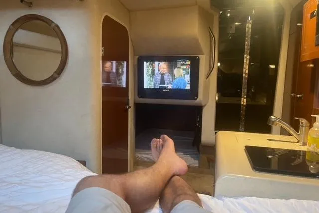 Slide: The Image of Cozy cabin interior of 2012 Sea Ray 260 Sundancer with TV and kitchenette. - 7