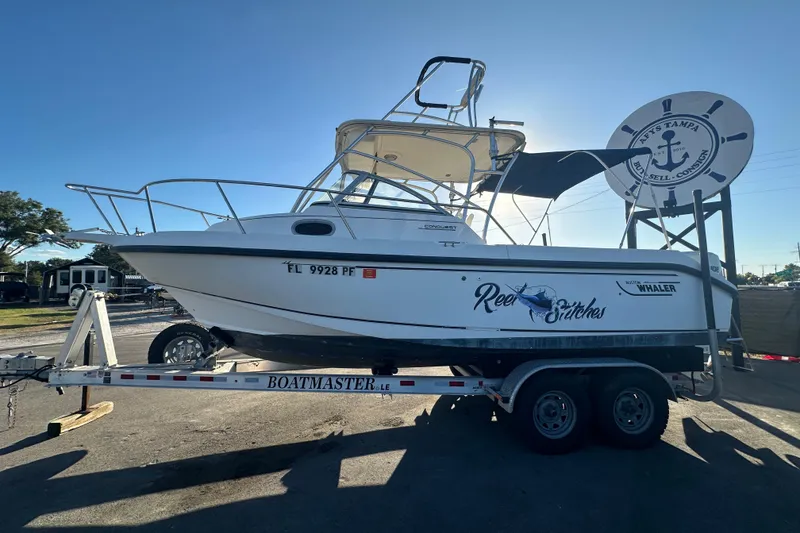 Slide: The Image of 2001 Boston Whaler 23 Conquest boat on trailer, side view, sunny day. - 10