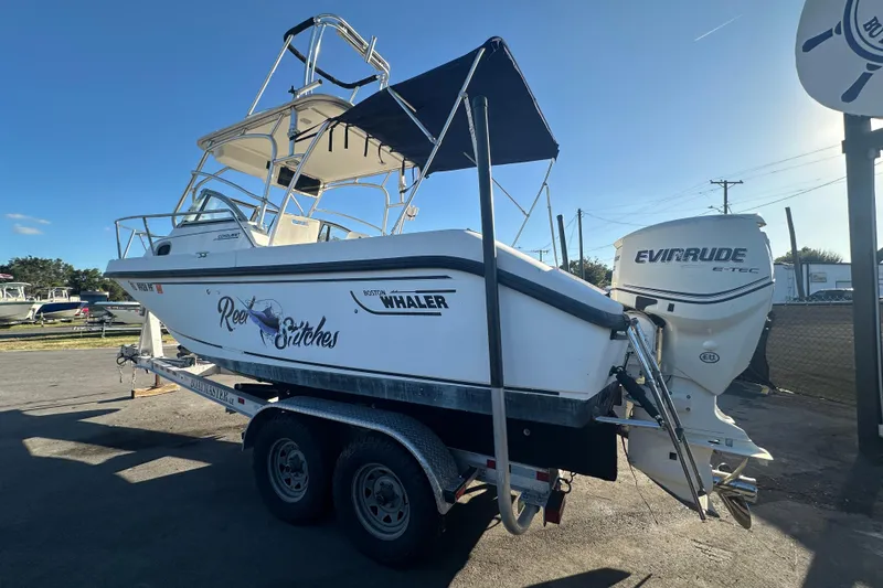 Slide: The Image of 2001 Boston Whaler 23 Conquest boat on trailer with Evinrude engine, side view. - 11