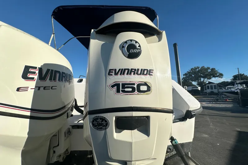 Slide: The Image of Evinrude 150 outboard motor on 2001 Boston Whaler 23 Conquest boat, sunny day. - 16