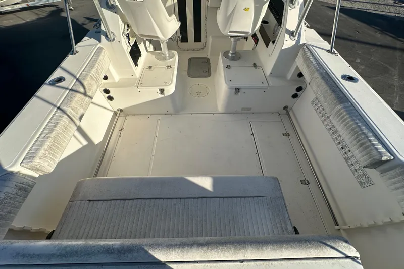 Slide: The Image of 2001 Boston Whaler 23 Conquest boat interior with seating and storage compartments. - 23