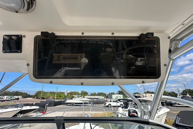 Slide: The Image of 2001 Boston Whaler 23 Conquest boat dashboard with electronics and switches. - 28