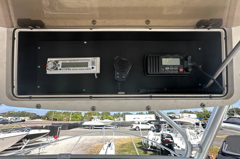 Slide: The Image of 2001 Boston Whaler 23 Conquest dashboard with radio and communication equipment. - 30