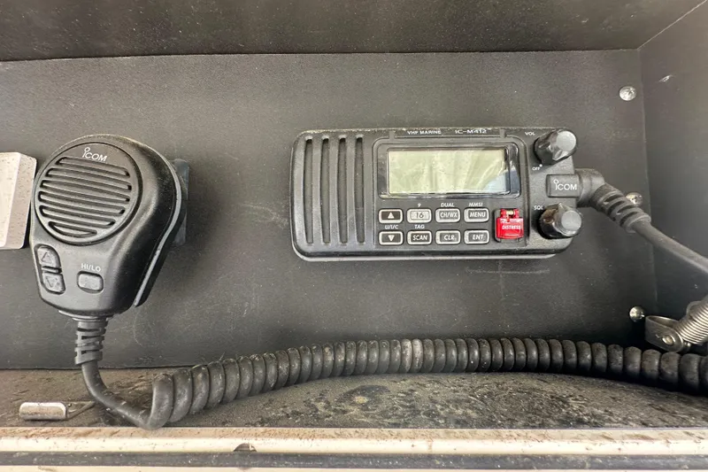 Slide: The Image of VHF marine radio and microphone on a 2001 Boston Whaler 23 Conquest boat. - 32