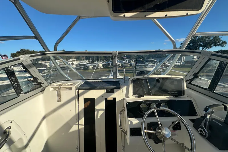 Slide: The Image of 2001 Boston Whaler 23 Conquest helm with steering wheel and navigation equipment. - 33