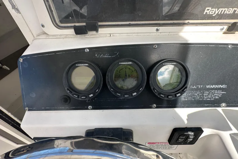 Slide: The Image of Dashboard of a 2001 Boston Whaler 23 Conquest boat with I-Command gauges. - 39