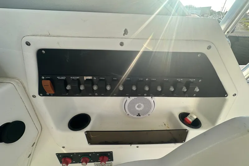 Slide: The Image of Control panel of a 2001 Boston Whaler 23 Conquest boat with sunlight streaming in. - 43