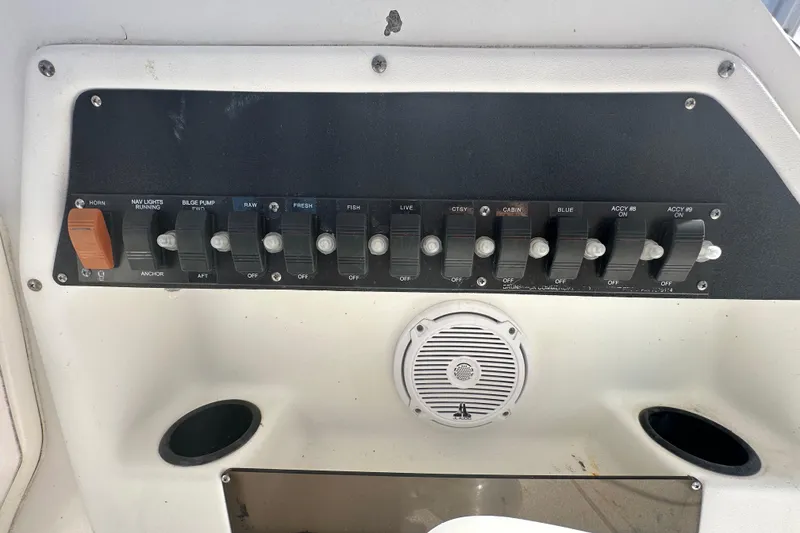 Slide: The Image of Control panel of a 2001 Boston Whaler 23 Conquest boat with various switches. - 44