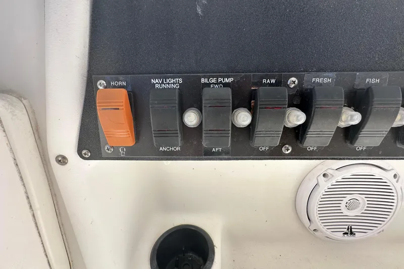 Slide: The Image of Control panel of a 2001 Boston Whaler 23 Conquest boat with switches and speaker. - 45