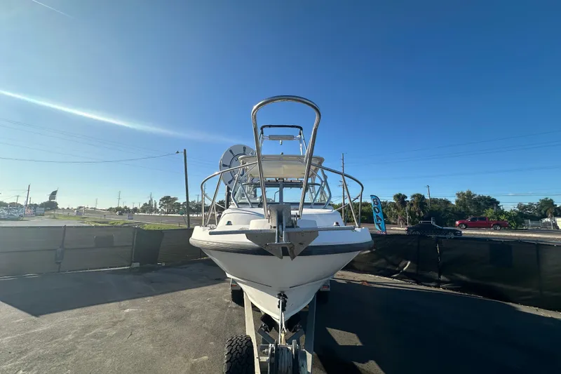 Slide: The Image of 2001 Boston Whaler 23 Conquest boat on trailer under clear blue sky. - 5