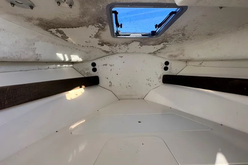 Slide: The Image of Interior cabin of a 2001 Boston Whaler 23 Conquest boat, showing ceiling and window. - 51