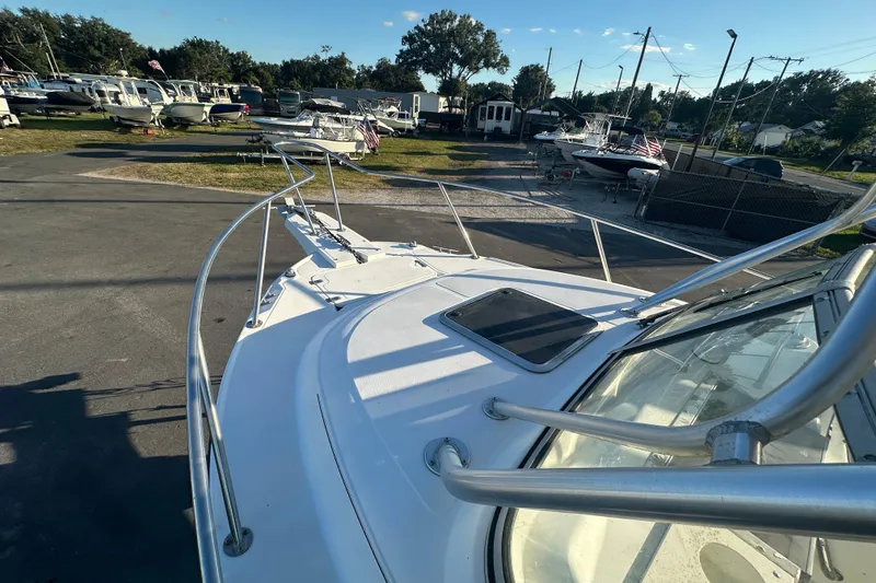 Slide: The Image of 2001 Boston Whaler 23 Conquest boat on display at a marina under clear skies. - 59
