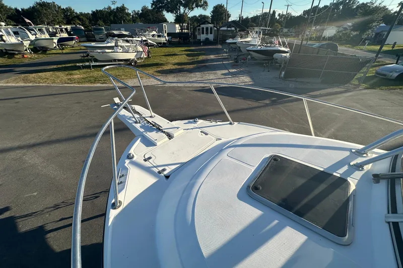 Slide: The Image of 2001 Boston Whaler 23 Conquest boat deck in a marina with other boats. - 60