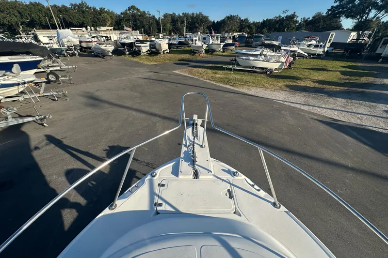 Slide: The Image of Bow view of 2001 Boston Whaler 23 Conquest in a boatyard setting. - 61