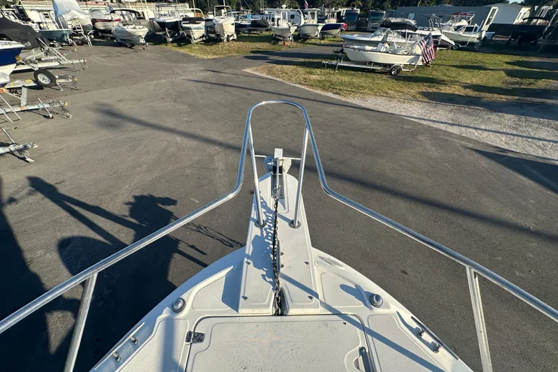 Slide: The Image of Bow view of 2001 Boston Whaler 23 Conquest in a boatyard setting. - 63
