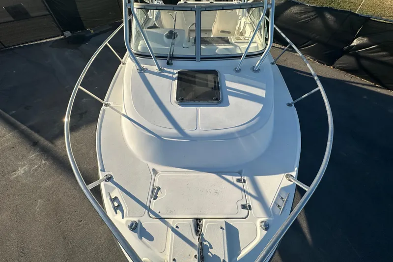 Slide: The Image of 2001 Boston Whaler 23 Conquest boat deck, featuring a spacious bow and sturdy railings. - 69