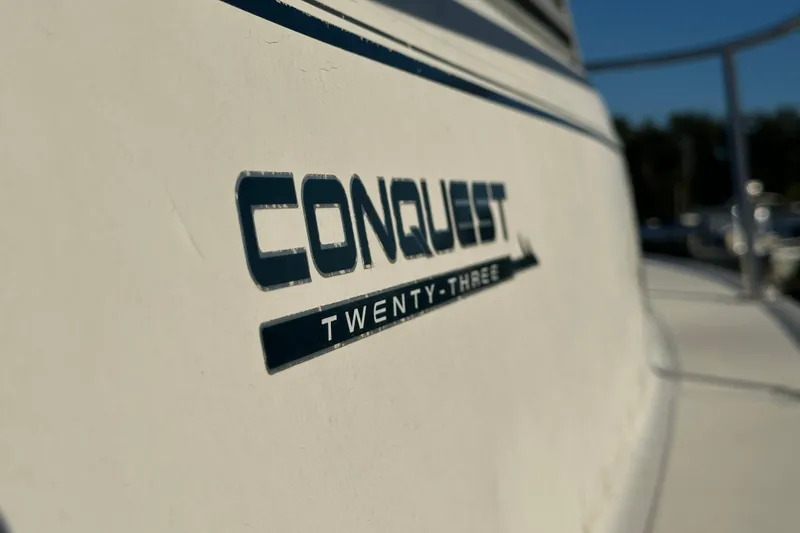 Slide: The Image of 2001 Boston Whaler 23 Conquest boat logo close-up in sunlight. - 74