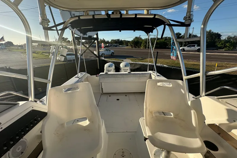 Slide: The Image of 2001 Boston Whaler 23 Conquest boat interior with seating and dual engines. - 78