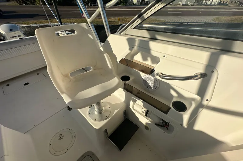 Slide: The Image of 2001 Boston Whaler 23 Conquest cockpit with helm seat and control panel. - 82