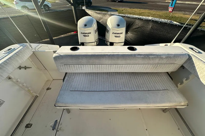 Slide: The Image of 2001 Boston Whaler 23 Conquest boat with Evinrude 150 engines and cushioned seating. - 89