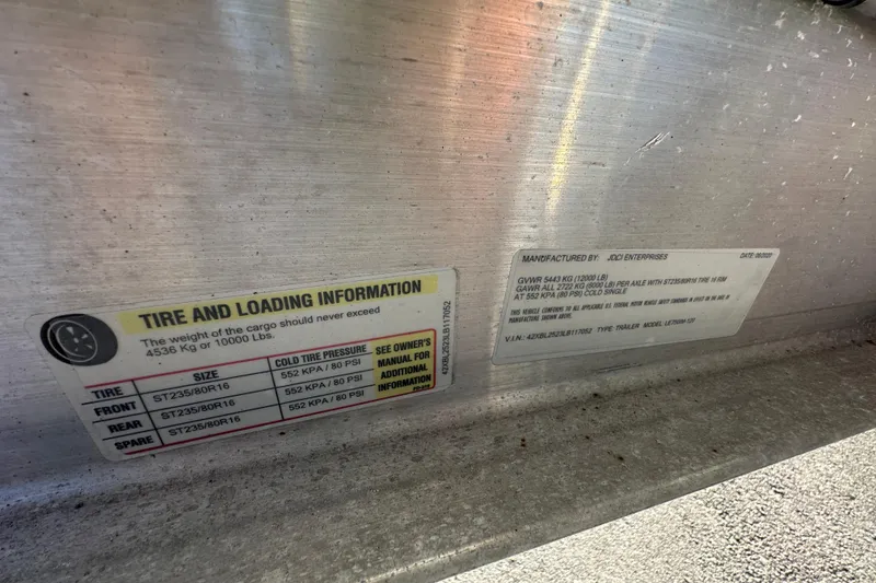 Slide: The Image of Tire and loading information label on a 2001 Boston Whaler 23 Conquest boat trailer. - 95