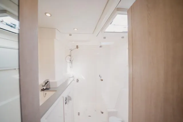 Slide: The Image of Luxurious bathroom interior of 2017 Leopard 51 Powercat yacht, featuring modern fixtures and natural lighting. - 100