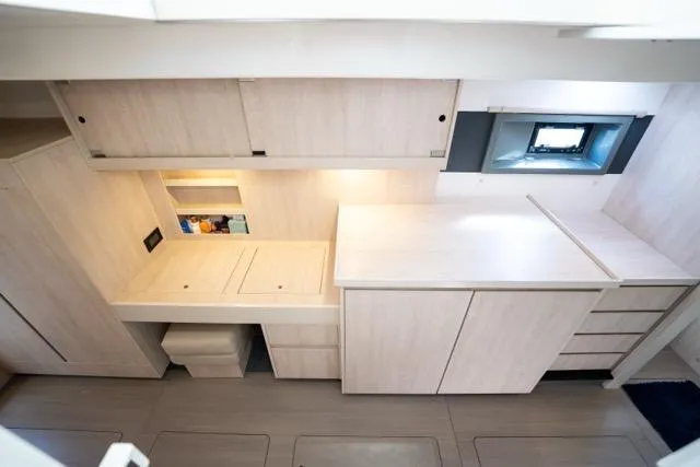 Slide: The Image of Modern interior of 2017 Leopard 51 Powercat with sleek cabinetry and compact design. - 104