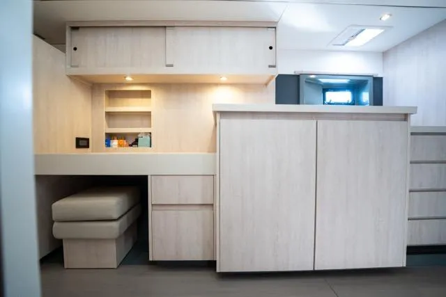 Slide: The Image of Interior of 2017 Leopard 51 Powercat with modern cabinetry and seating area. - 105