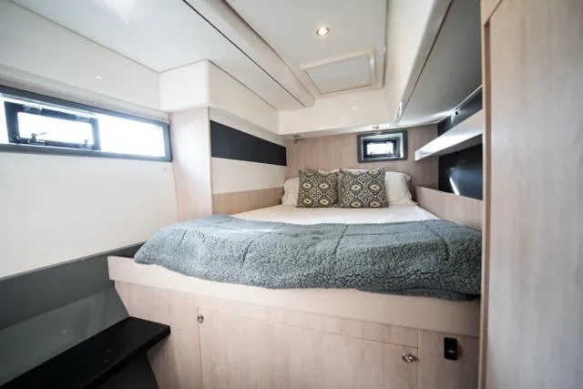 Slide: The Image of 2017 Leopard 51 Powercat cabin with cozy bed, modern design, and natural light. - 117