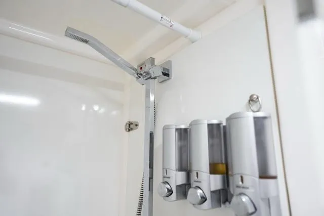 Slide: The Image of Shower area in 2017 Leopard 51 Powercat with modern dispensers and sleek fixtures. - 127