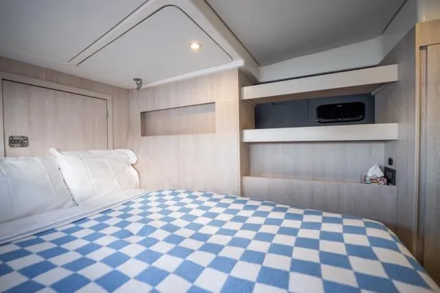 Slide: The Image of Cozy bedroom in 2017 Leopard 51 Powercat with checkered bedding and modern shelving. - 131