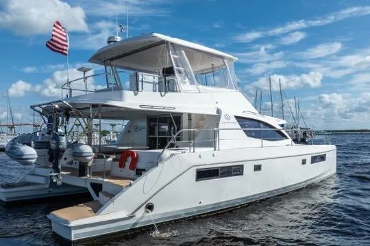 Slide: The Image of 2017 Leopard 51 Powercat yacht on water, American flag, clear sky, marina background. - 135