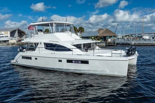 Slide: The Image of 2017 Leopard 51 Powercat yacht docked in a marina under a blue sky. - 138