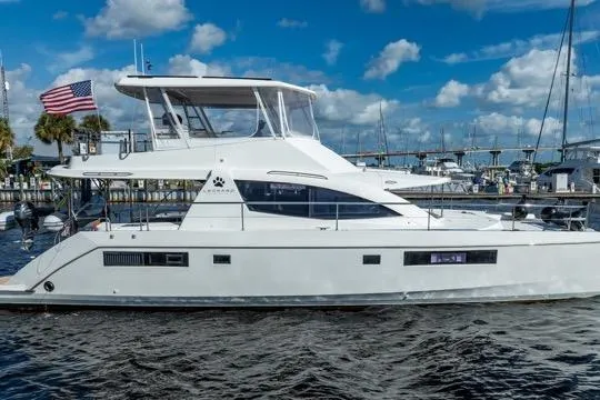 Slide: The Image of 2017 Leopard 51 Powercat yacht docked at marina under blue sky. - 140