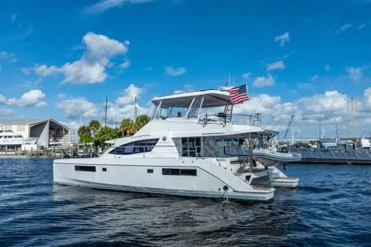 Slide: The Image of 2017 Leopard 51 Powercat yacht cruising on a sunny day with an American flag. - 144