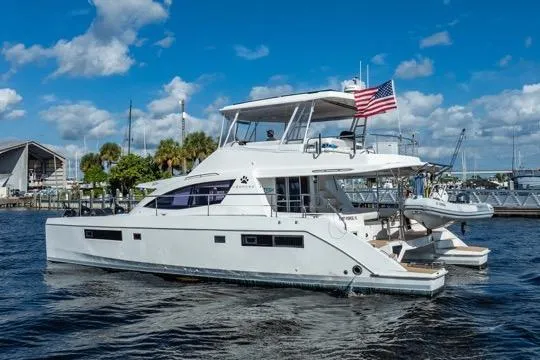 Slide: The Image of 2017 Leopard 51 Powercat yacht on water, American flag, sunny day, marina background. - 145