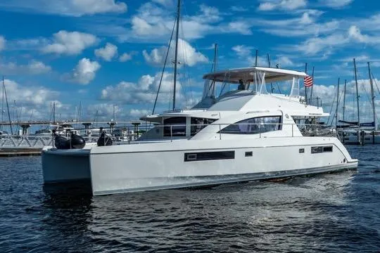 Slide: The Image of 2017 Leopard 51 Powercat yacht docked in marina under blue sky. - 148