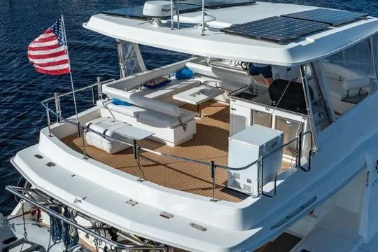 Slide: The Image of 2017 Leopard 51 Powercat yacht with spacious deck, solar panels, and American flag. - 157
