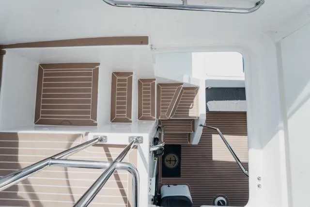 Slide: The Image of Staircase on 2017 Leopard 51 Powercat with sleek wooden finish and stainless steel railings. - 19
