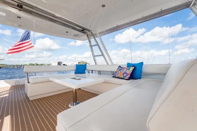 Slide: The Image of Luxurious 2017 Leopard 51 Powercat yacht with spacious seating, American flag, and scenic water view. - 21