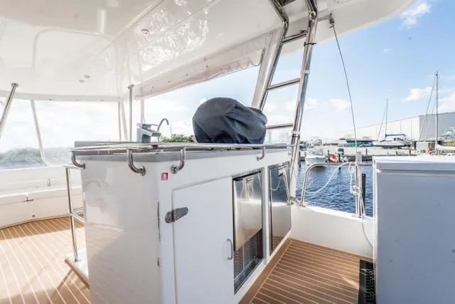 Slide: The Image of 2017 Leopard 51 Powercat yacht deck with outdoor kitchen and marina view. - 28