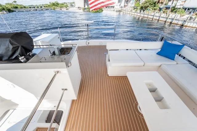 Slide: The Image of 2017 Leopard 51 Powercat deck with seating, sink, and scenic waterfront view. - 32