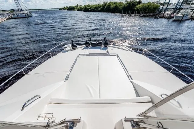Slide: The Image of 2017 Leopard 51 Powercat yacht deck overlooking serene waters and lush shoreline. - 35