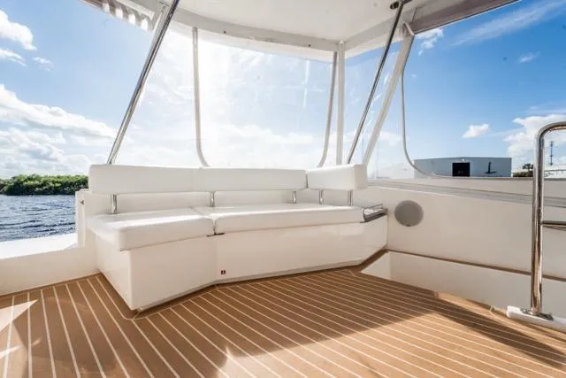 Slide: The Image of 2017 Leopard 51 Powercat interior with white seating and wooden flooring. - 36